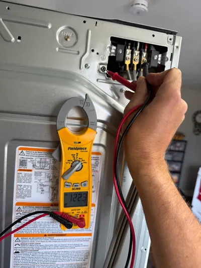 Testing voltage at an appliance terminal block during a Denver appliance repair service call