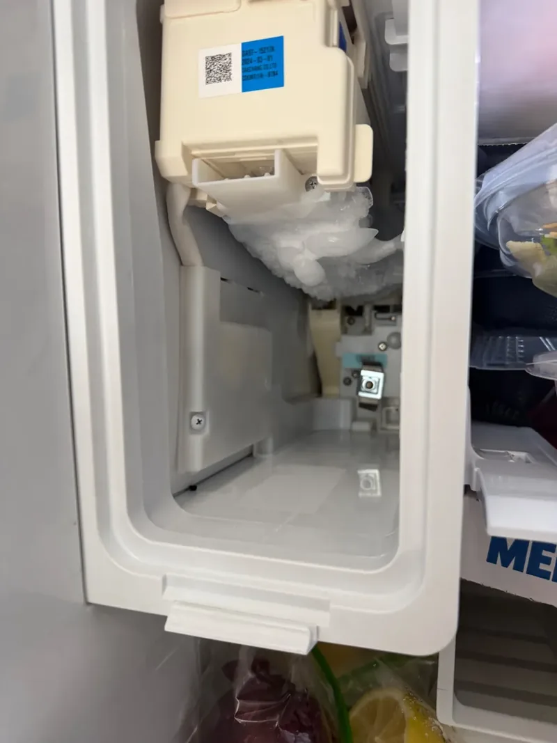 Frost buildup around a refrigerator ice maker during a Denver ice maker repair