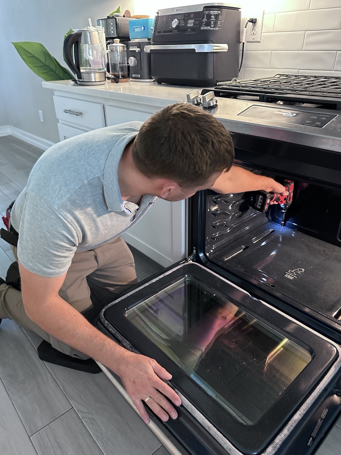 Victor repairing an oven during an appliance service call in the Lone Tree area